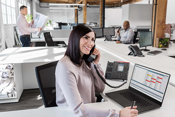 Woman on Allworx business phone